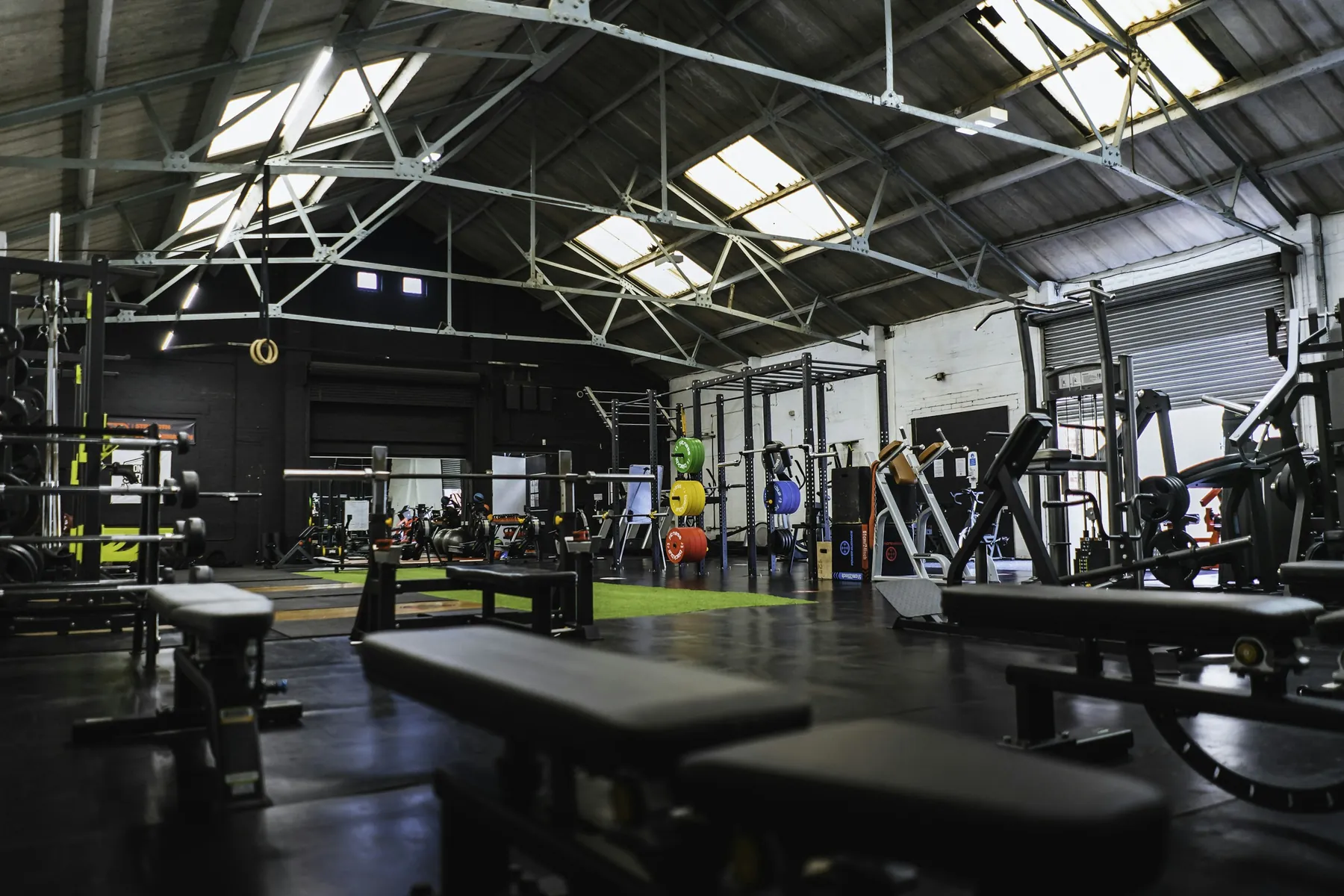 An industrial gym with racks and daylight